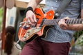 guitarist playing guitar with rock group in the stree