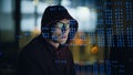 Closeup hacker breaking website in code lines neon projection. Guy looking back Royalty Free Stock Photo