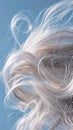 Closeup of hair with cloudlike softness capturing the texture and lightness against a skyblue background