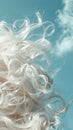 Closeup of hair with cloudlike softness capturing the texture and lightness against a skyblue background