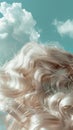 Closeup of hair with cloudlike softness capturing the texture and lightness against a skyblue background