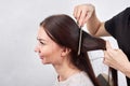 Closeup of hair stylist combing client`s hair in salon Royalty Free Stock Photo