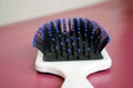 Closeup of hairbrush with white handle, blue bristles,macro photography Royalty Free Stock Photo