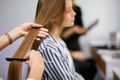 Closeup of hairdresser combing client`s hair Royalty Free Stock Photo