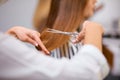 Closeup of hairdresser cutting off long hair Royalty Free Stock Photo