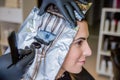 Closeup of hairdresser hands applying hair dye to client