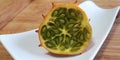 Half fresh kiwano on dish on blurred wooden background.Vegetarian healthy diet