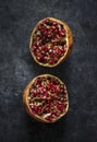 Closeup of half fresh pomegranate on black background