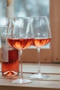 A closeup of rose wine bottle and two filled glasses Royalty Free Stock Photo