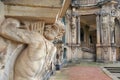 Closeup half naked faunus statue under column with panpipe at Zwinger palace in Dresden Royalty Free Stock Photo