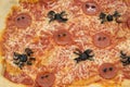 Closeup of Halloween Pizza with Spider-Shaped Pepperoni and Olives