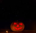 Closeup Halloween Pumpkin With Candles  On Starry Sky Background