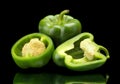 Closeup halved green bell peppers isolated on black