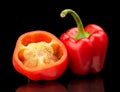 Closeup halved red bell peppers isolated on black