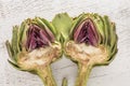 Halved ripe artichokes on a wooden table