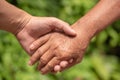 Closeup hand of the adult and the old people grasp together.