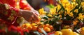 A Closeup Of A Hand Arranging Auspicious Fruits And Flowers For A Festive Display