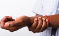 Black man holds his wrist hand injury, feeling pain Royalty Free Stock Photo