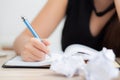 Closeup hand asian woman writer thinking idea and writing on notebook or diary with happy on desk office