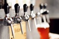 Closeup hand barman dark craft cold beer pour in glass from crane in pub Royalty Free Stock Photo