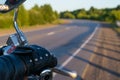 The hand of the biker on the control handle of the motorcycle and the view of the road Royalty Free Stock Photo