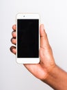 Black man holding mockup white modern digital mobile smart phone blank screen on hand Royalty Free Stock Photo