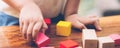 Closeup hand of boy playing wooden block toy on table for creative with enjoy, happy child learn skill for activity puzzle. Royalty Free Stock Photo