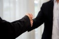 Closeup hand of business man and woman standing and shake hands while agreement of negotiation success. Royalty Free Stock Photo