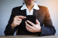 Closeup hand of business woman using smart mobile phone at office Royalty Free Stock Photo