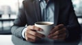 Closeup hand of businessman holding a coffee cup in the cafe. Generative AI