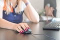 Woman`s hand using computer mouse on a desk. Closeup shot of female hand holding mouse and working with desktop computer Royalty Free Stock Photo