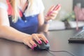 Closeup of hand businesswoman using mouse to working desktop and holding smartphone to connect online