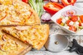 Italian kitchen and cooking concept. Chief with a pizza cutter cutting pizza to pieces at Neapolitan pizzeria. Royalty Free Stock Photo