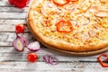 Pizza with chicken, paprika and corn. Italian kitchen and cooking concept. Chief with a pizza cutter cutting pizza to Royalty Free Stock Photo