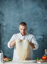 Closeup hand of chef baker in white uniform making pizza at kitchen Royalty Free Stock Photo