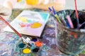 Closeup,hand of child girl with artistic tools on table,drawing and palette,paintbrush to painting watercolor,learning,activity Royalty Free Stock Photo