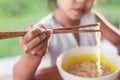 Closeup on hand of child girl holding chopstick