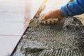 closeup hand construction worker laying tile