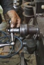 Closeup of a hand crank with mechanics operating the machine, old Lathe Machinery. Vintage Industrial Machinery in a old factory. Royalty Free Stock Photo