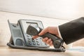 Closeup of a hand in a formal elegant suit dialing a telephone n Royalty Free Stock Photo