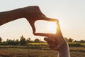 closeup hand framing view distant over sunset. business concept Royalty Free Stock Photo