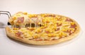 Closeup of a hand getting a slice of mouth-watering cheesy pizza isolated on a white background