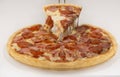 Closeup of a hand getting a slice of mouth-watering cheesy pizza isolated on a white background