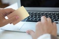 Closeup hand of girl typing credit card details on laptop to complete payment process. Shallow depth of field with focus