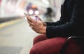 Closeup hand of hipster senior man chatting on his smartphone while waits for subway train - Mature man having fun with technology