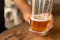 Closeup hand hold Beer mug on table Royalty Free Stock Photo