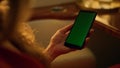 Closeup hand hold green screen phone. Middle aged woman using mockup device Royalty Free Stock Photo