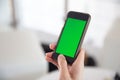 Closeup hand hold smartphone with green screen Royalty Free Stock Photo