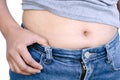 Closeup hand holding abdominal surface woman fat, healthy care and beauty concept