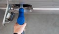 Closeup hand holding blue gas pump nozzle. Gas station worker filling up bronze pickup truck tank. Top View Royalty Free Stock Photo